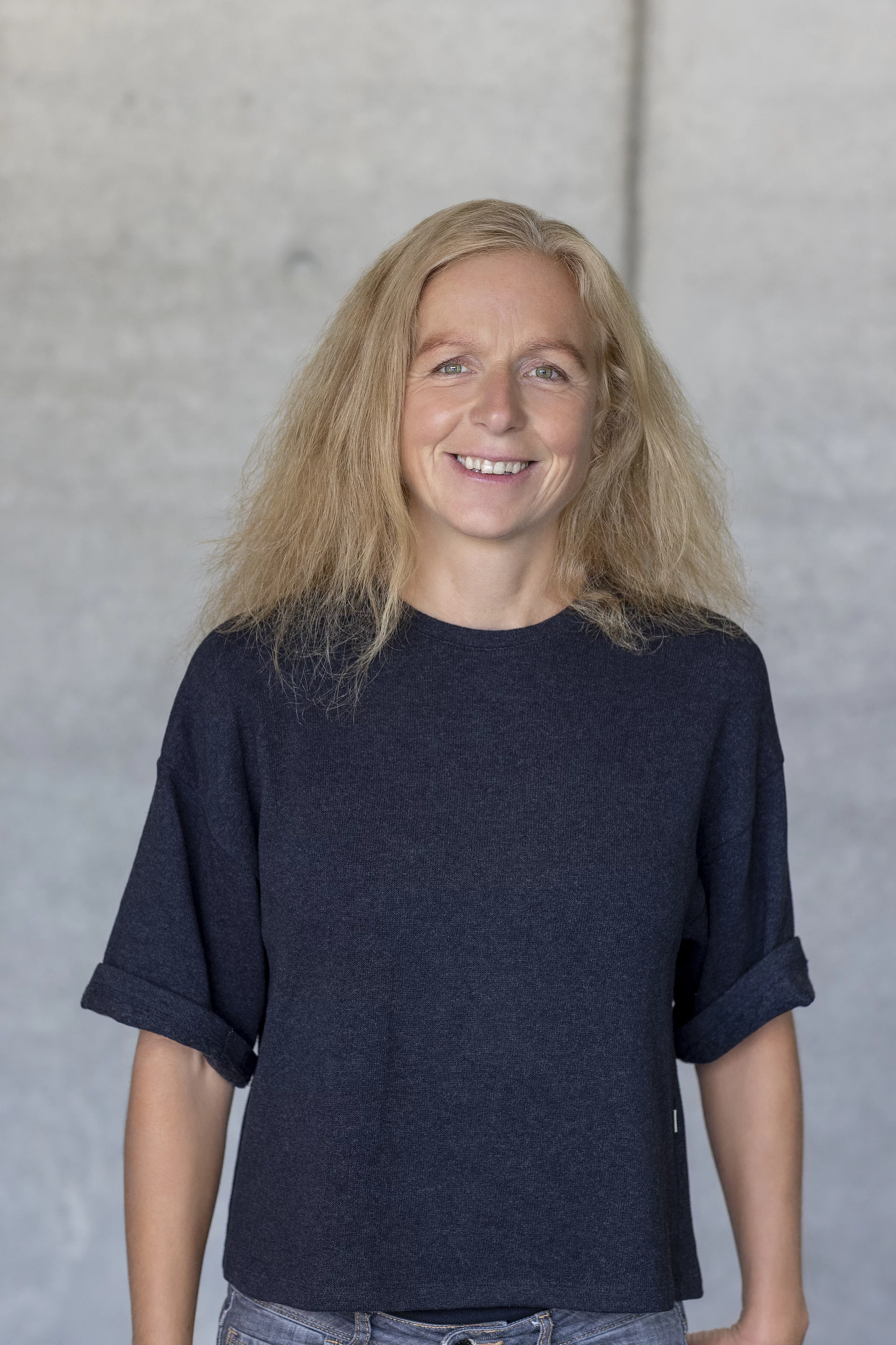 Gesellschafterin Meike Bauer Porträt von Meike Bauer, Gesellschafterin, frontal aufgenommen und lächelnd vor unscharfem Hintergrund.